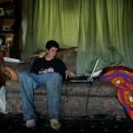 Sultan High School dropout Stephen Giziniski fiddles with his laptop inside his motherÕs trailer June 24, 2005 in Sultan, Wash.  Giziniski, age 16, spends most of his time watching television and playing video games on his computer.