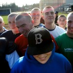 Colton Wilson,16, (at center in hat) smiles as he is surrounded by his South Whidbey High School baseball teammates who all recently shaved their heads for him March 5, 2007.  Wilson, of Langley, Wash., is undergoing treatment for cancer.  Instead of asking the Make-A-Wish Foundation for something for himself, he asked for improvements to his high school baseball field.